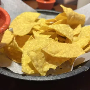 a plate of chips and a bowl of salsa