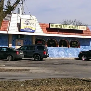 cars parked in front of a restaurant