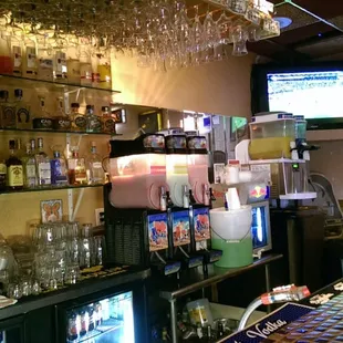 Margaritas waiting to go from a slurpee machine at the bar.