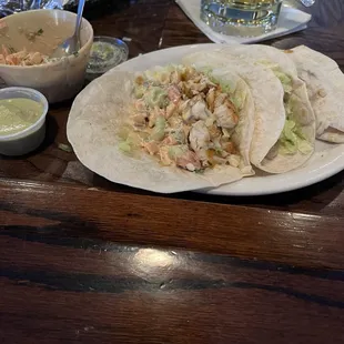 Fish tacos served with a creamy salsa and verde sauce. Very good!