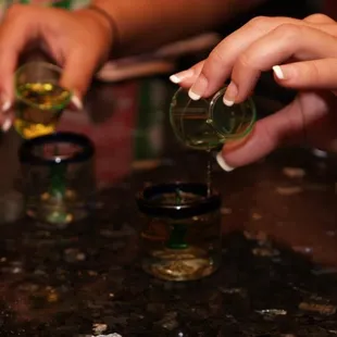 a person pouring a drink