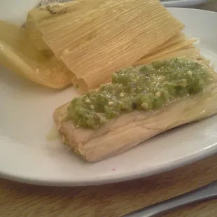 Loaded tamale with salsa verde.