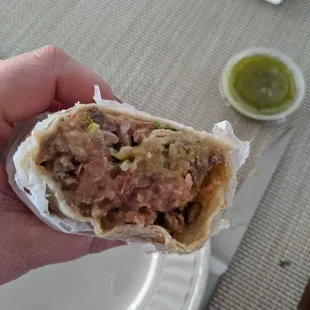 Carne asada burrito (cut in half to show filling)