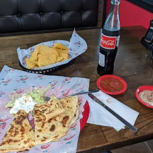 Tasty Asada quesadilla, a REAL Coke and wonderful bean and salsa dips. Chips are crispy. Excellent lunch.