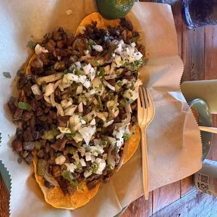 a plate of tacos with a fork and knife