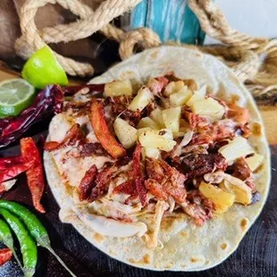 a tortilla with meat and vegetables