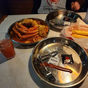 a plate of hotdogs, french fries, and a bowl of hotdogs
