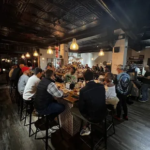 a large group of people sitting at a table