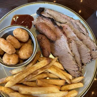 Smoked Brisket with a side of fries and corn nuggets.
