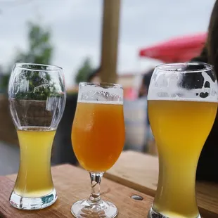 three glasses of beer on a table