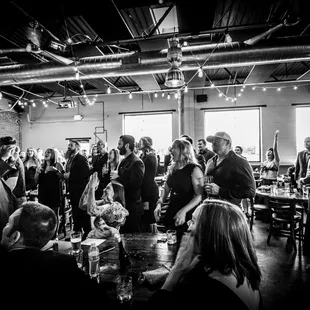 a large group of people standing and sitting