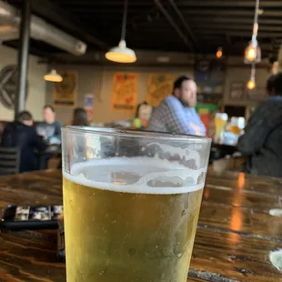 a pint of beer on a table
