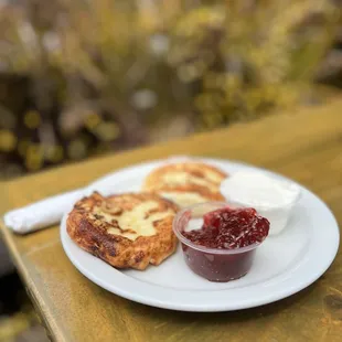 Syrniki with sour cream and jam. I prefer it with the sour cream