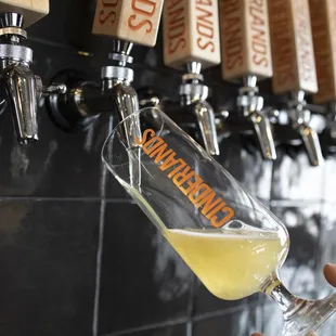  person pouring a glass of beer