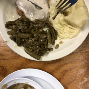 Country fried steak, green beans, boiled cabbage and mashed potatoes lunch special for $6.95.