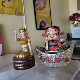 a bowl of donuts and a figurine