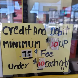 a sign in the window of a donut shop