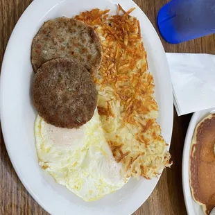 Eggs Sausage Patties and Hash Browns and a Pancake