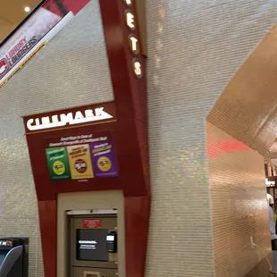 Ticket kiosk by the escalator.