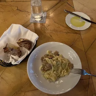 Bread tasting. The white one was white sourdough and the dark one was olive sourdough. In the plate with a knife there was some olive oil.