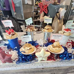 a display of cupcakes and desserts