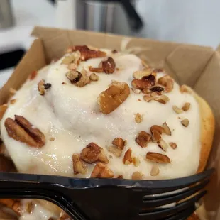 a pastry in a box with a fork