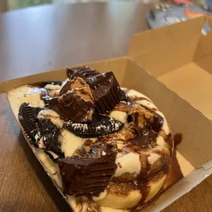 Custom Roll (cake batter frosting, peanut butter cups, Oreo bites, chocolate sauce)