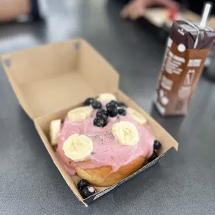 a donut with blueberries and banana slices