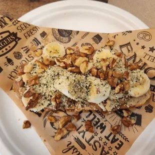 Almond butter, banana, hemp seeds and walnut toast on homemade sourdough bread. No honey to make it vegan