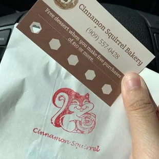 a hand holding a business card