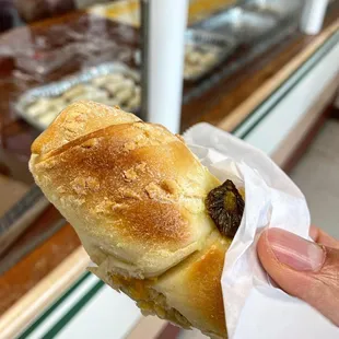 a hand holding a pastry