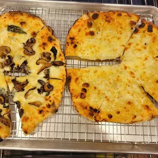two pizzas on a cooling rack