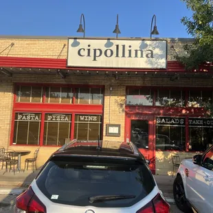 cars parked in front of a restaurant