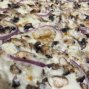 a pizza with onions and mushrooms