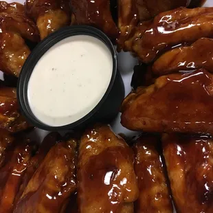 a plate of chicken wings with sauce