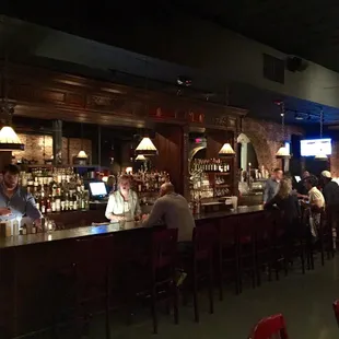 people sitting at a bar in a restaurant