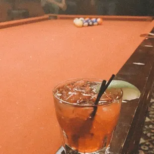 a drink on a pool table