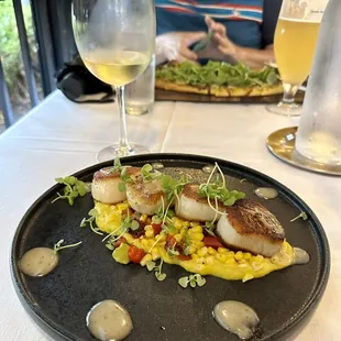 Scallops with summer corn succotash, sweet corn puree, and charred lemon emulsion. Delicious!