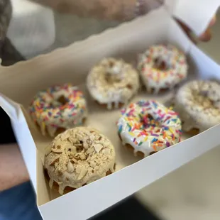 a box of doughnuts with sprinkles