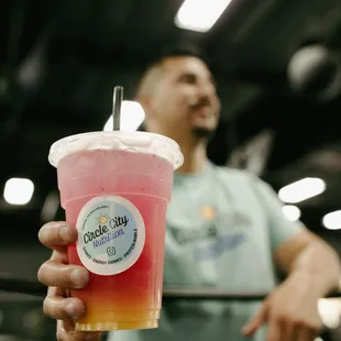 a man holding a drink