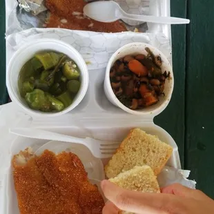 a person holding a piece of breaded fish