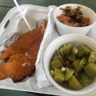 a tray of fried fish and vegetables
