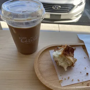 a half eaten donut and a cup of coffee