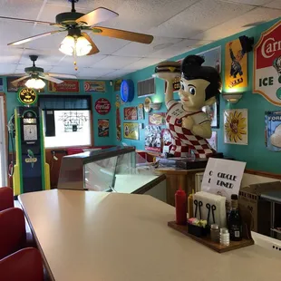 a restaurant counter with a statue of a man