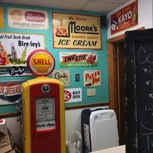 a vintage gas pump and other signs