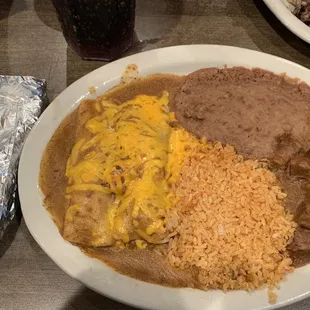 Chicken enchiladas, Carne Guisada, Rice, and Beans.