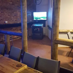 a table and chairs with a television in the background