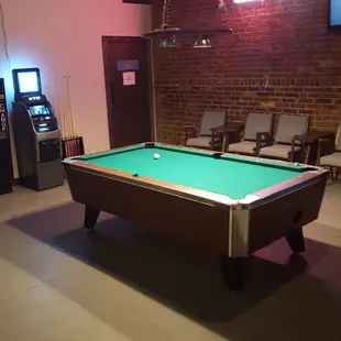 a pool table and arcade machines