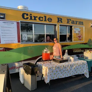 a woman standing in front of a food truck
