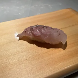 a piece of raw tuna on a cutting board